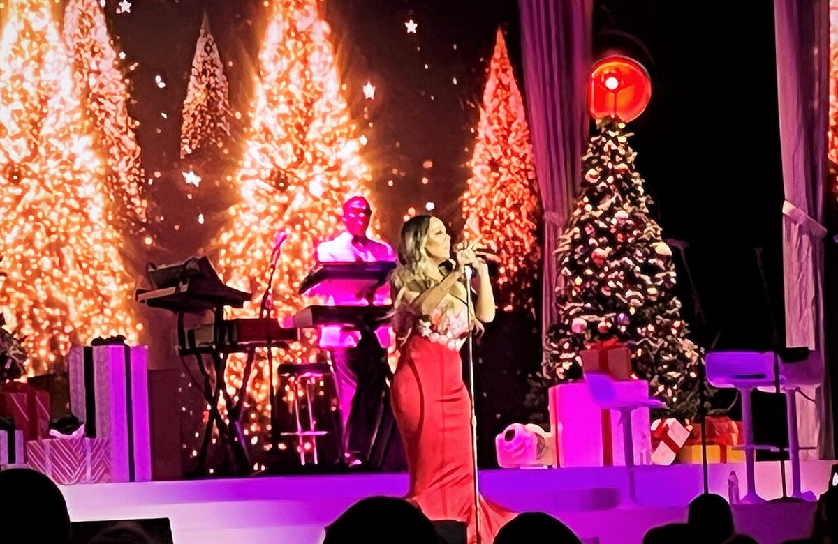 Mariah Carey performing among Christmas trees in Toronto in December 2022