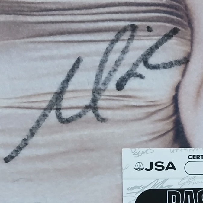 A signed photograph displayed with a JSA authentication card in the same frame; the certificate number is not legible in this photograph and is not claimed.